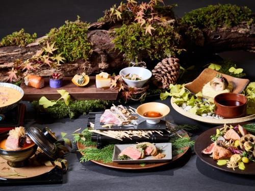 a table topped with plates of food and other foods at ANDO HOTEL NARA Wakakusayama -DLIGHT LIFE & HOTELS- in Nara