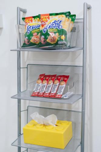 a refrigerator rack with snacks and a block of cheese at Free Netflix 3BR 10 Mins to City Center 3 Mins 7-11 in Hat Yai
