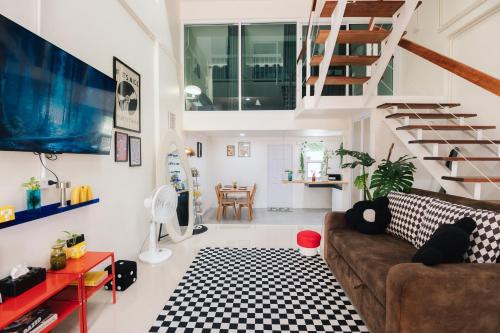 a living room with a couch and a staircase at Free Netflix 3BR 10 Mins to City Center 3 Mins 7-11 in Hat Yai