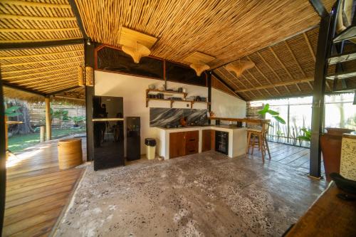 a large room with a kitchen and a living room at Villa Kesambi in Gili Air