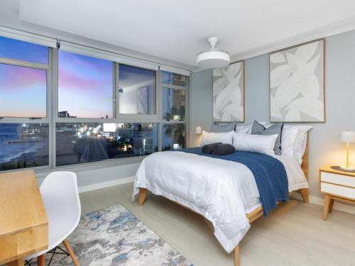 a bedroom with a bed and a large window at Sandy Shores On Beach - 709 in Strand