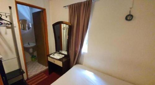 a bedroom with a mirror and a bed and a sink at OYO 1167 Rest and Go Hotel Klang in Klang
