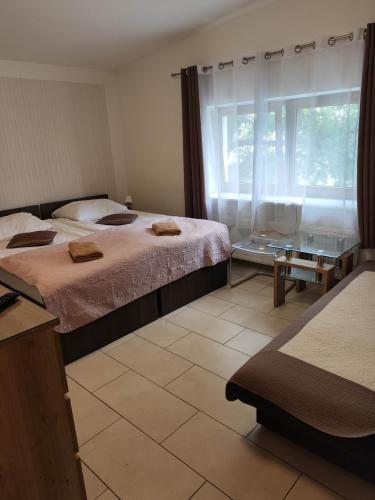 a hotel room with two beds and a window at Eleven Pokoje in Gdynia