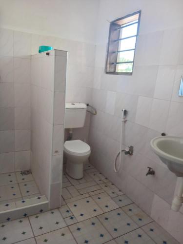 a bathroom with a toilet and a sink at Dannys&nickson holiday homes in Watamu