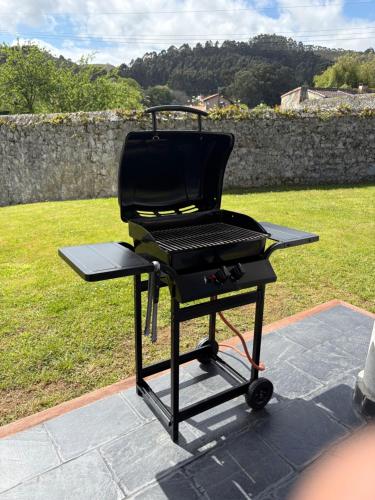 a bbq grill sitting on top of a patio at Casa El Lloréu in Naves