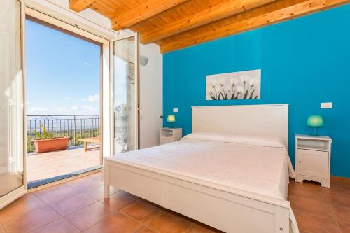 a bedroom with a bed and a large window at Oasi Dell'Etna in Belpasso