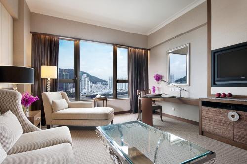 a living room with a couch and a tv at Sofitel Macau At Ponte 16 in Macau