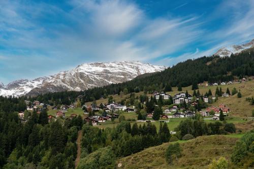 a village in a valley with snow covered mountains at Casetta di Carì by Quokka 360 - spacious family flat in Cala