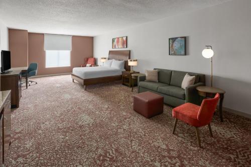 a hotel room with a bed and a couch at Hilton Garden Inn State College in State College