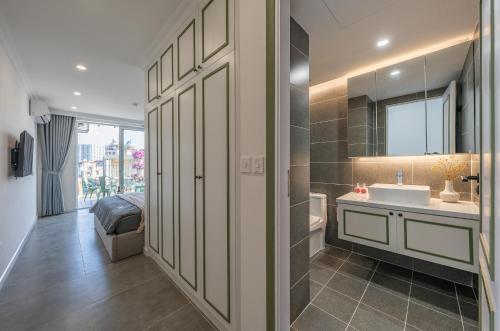 a bathroom with a sink and a mirror at Twilight Townhouse w Lift in Hanoi