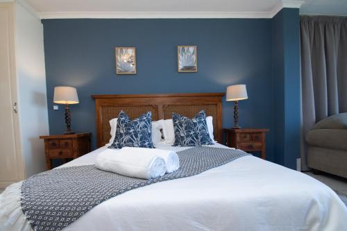 1 dormitorio azul con 1 cama grande y paredes azules en 27 Kyalanga Umhlanga Rocks Beachfront, en Durban