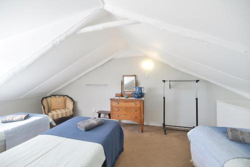 a attic room with two beds and a dresser at Talana's Stay - 17 Hugo in Bredasdorp