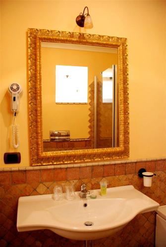 a bathroom with a sink and a mirror at Hotel Villa Enrica - Aeolian Charme in Lipari