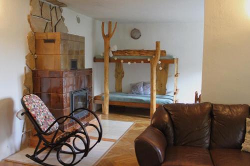 a living room with a couch and a fireplace at Chata na Bunči in Roštín