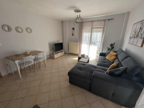 a living room with a couch and a table at Byron suite in Kavala