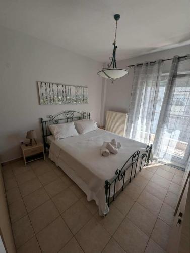 a bedroom with a bed and a chandelier at Byron suite in Kavála