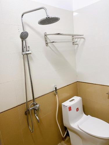 a bathroom with a shower and a toilet in it at Ngoc Toan Retreat in Dong Hoi