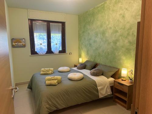 a bedroom with a bed with pillows on it at Il Sogno di Olly - Assisi in Santa Maria degli Angeli