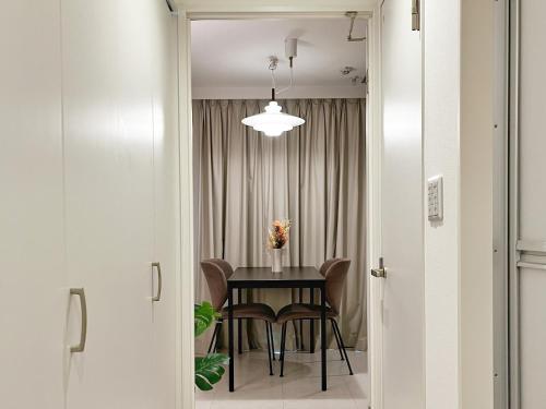 a dining room with a table and chairs at Roppongi Place in Tokyo