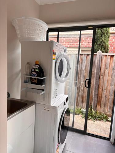 a washer and dryer in a kitchen with a window at Mahzan on Dromana Room 3 in Truganina