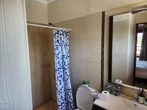 a bathroom with a shower with a toilet and a sink at Ponta Serenity Spot in Lopes