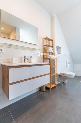 a bathroom with a sink and a toilet at Ferien & Business Apartments Hohenfels in Hohenfels