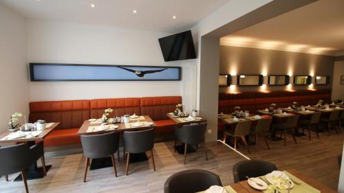 a dining room with long tables and chairs at Hotel zum Adler - Superior in Bonn