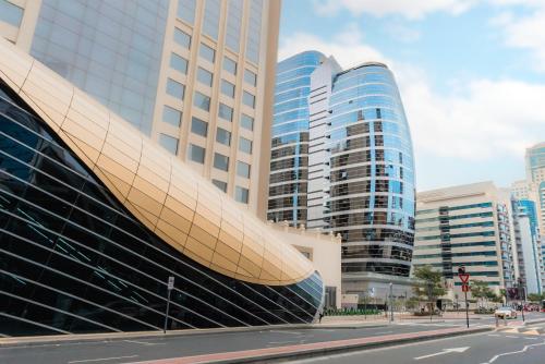 a view of a building in a city with tall buildings at Citadines Metro Central Dubai in Dubai