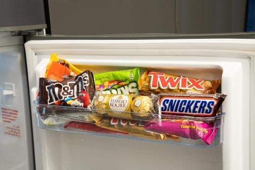 a refrigerator filled with lots of candy and snacks at Prime Suites Hotel in Yerevan