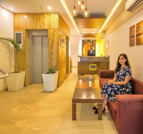 a woman sitting on a couch in a lobby at Via Le Grand in New Delhi