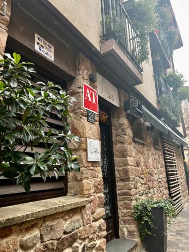 a sign on the side of a brick building with a door at Apartamentos Ubaga in Ezcaray