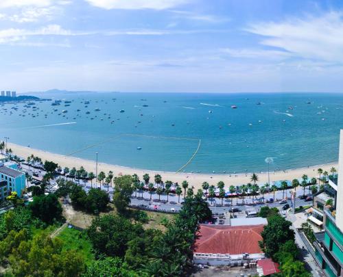 a view of a beach with boats in the water at Pattaya Beach View Talay 6 by AEGEAN Suite Condo in Pattaya
