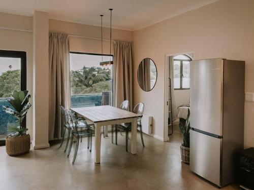a dining room with a table and chairs at The Place to Stay in Plettenberg Bay