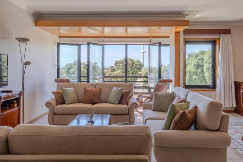 a living room with two couches and a table at Vista Atlântica-Vila do Conde in Vila do Conde