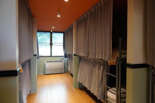 a group of bunk beds in a room with curtains at Nitra Hostel in Ban Nong Chaeng