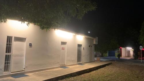 a white building with two doors on it at night at Habitaciones Privadas En Valledupar in Valledupar