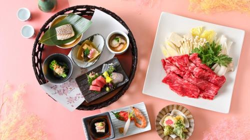 a table with plates of food on a pink table at LiVEMAX Resort Nasu Kogen in Nasu