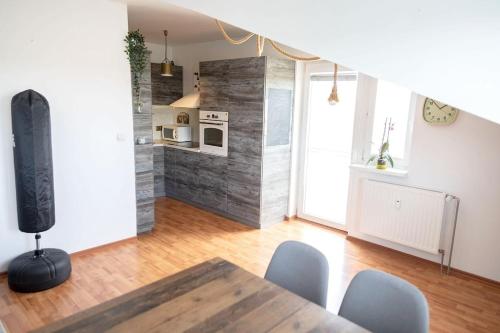 a living room with a table and chairs and a kitchen at 2-room apartment near Xbionic-sphere and Bratislava in Nová Lipnica