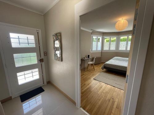 a bedroom with a bed and a table and window at Chambre cozy avec sdb privée à 7min de la gare in Redon