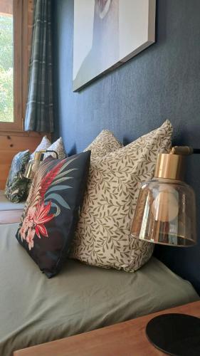 a couch with pillows and a lamp on it at Gîte Ancolie Bleue in Abriès