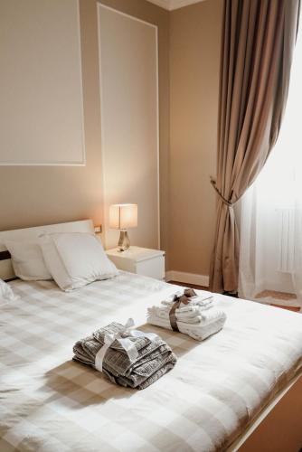 a bedroom with a bed with two towels on it at B&b Piazzetta in Fermo