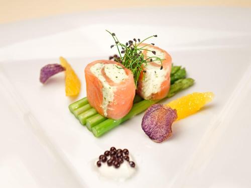 a plate of food with vegetables on a white plate at Hotel Lärchenhof in Katschberghöhe