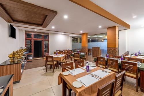 a restaurant with tables and chairs in a room at Sterling Govardhana Malampuzha in Palakkad