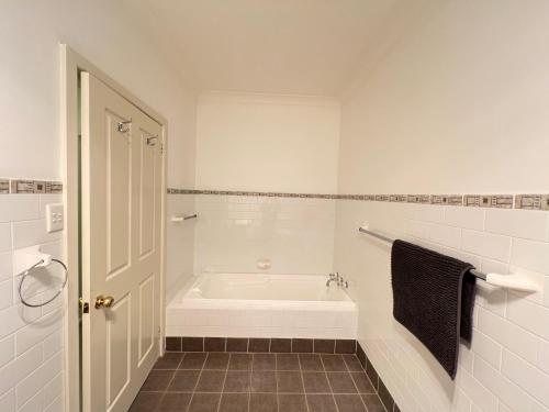 a white bathroom with a tub and a shower at Twin Room Ideal for Friends and Travelers - R5 in Sydney