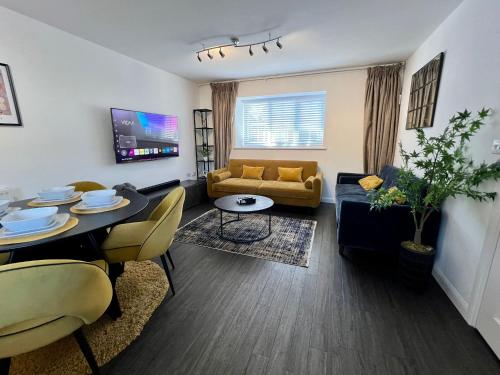 a living room with a couch and a dining room at Luxury 2 bed house in Dartford, United Kingdom in Dartford