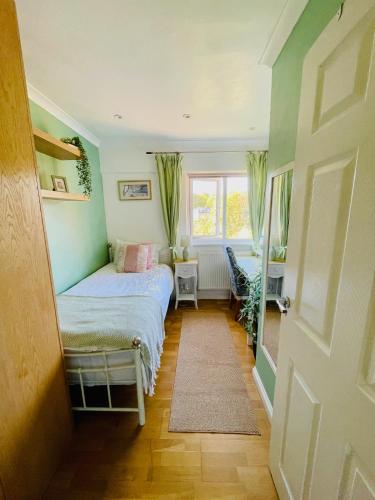 a small bedroom with a bed and a window at Modern and chic rooms with beautiful landscape views in Sydenham