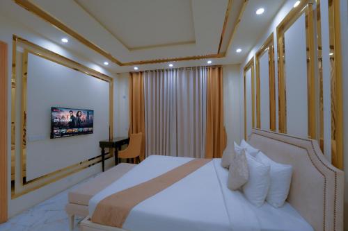 Ένα ή περισσότερα κρεβάτια σε δωμάτιο στο MB Residencia Hotel Suites