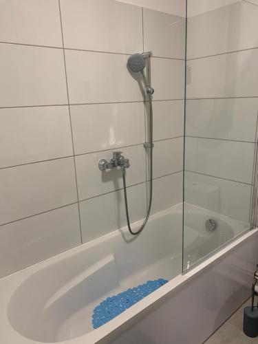a shower in a bathroom with a tub at Joli studio agréable neuf in Canet-en-Roussillon