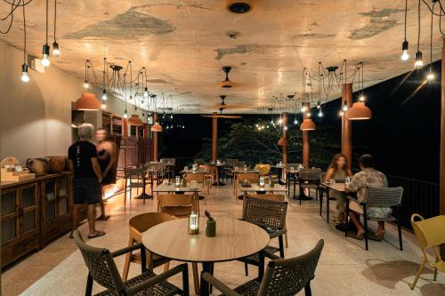 a restaurant with tables and people sitting at tables at NiiRA in Mirissa