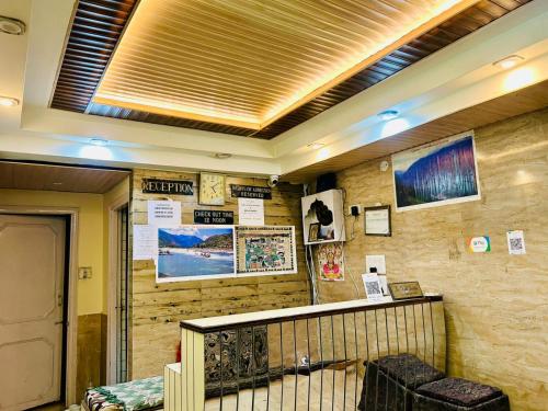 a room with a wall with posters on it at Family Hotel Sorya in Shimla